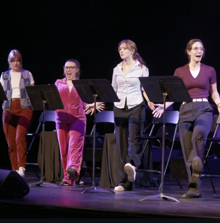 Four women, cast members, dancing on the stage